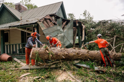 team of people from Samaritan’s Purse removing a tree and debris, Photo Courtesy of Samaritan’s Purse